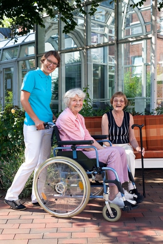 Smiling,Health,Care,Professionals,Taking,Care,An,Elderly,Patient,In